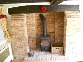 Willmont designed re-claimed brick fireplace with Oak mantelpiece